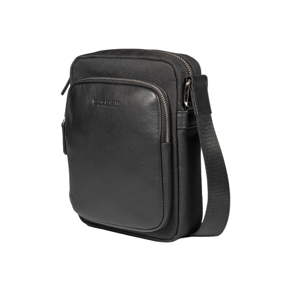 RB2002A | Nylon/Genuine Leather Shoulder Bag with a light grain. Zip closure and adjustable shoulder strap. Color: Black. Dimensions: 15.5 x 21 x 7 cm. Packaging: Non-woven fabric bag.-0